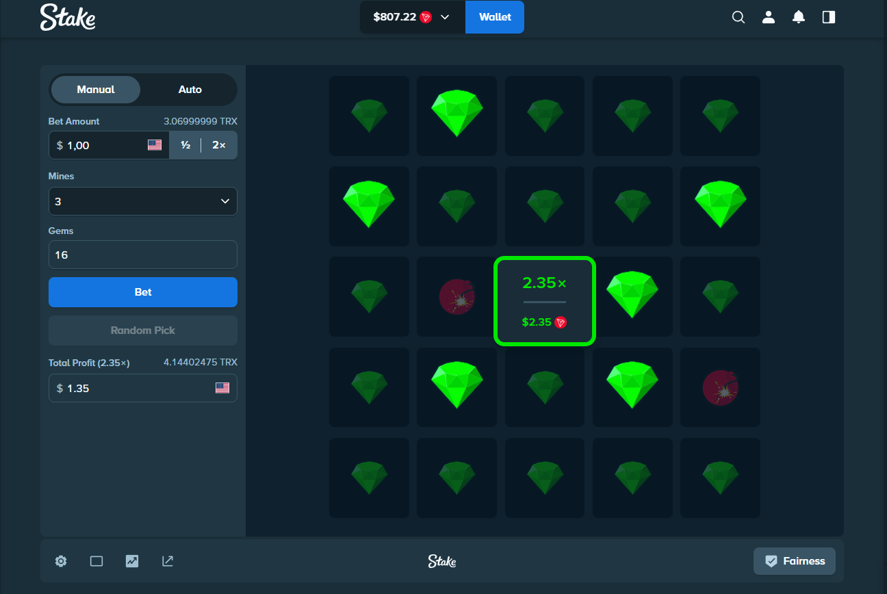 Stake Mines interface showing the gem grid and round settings